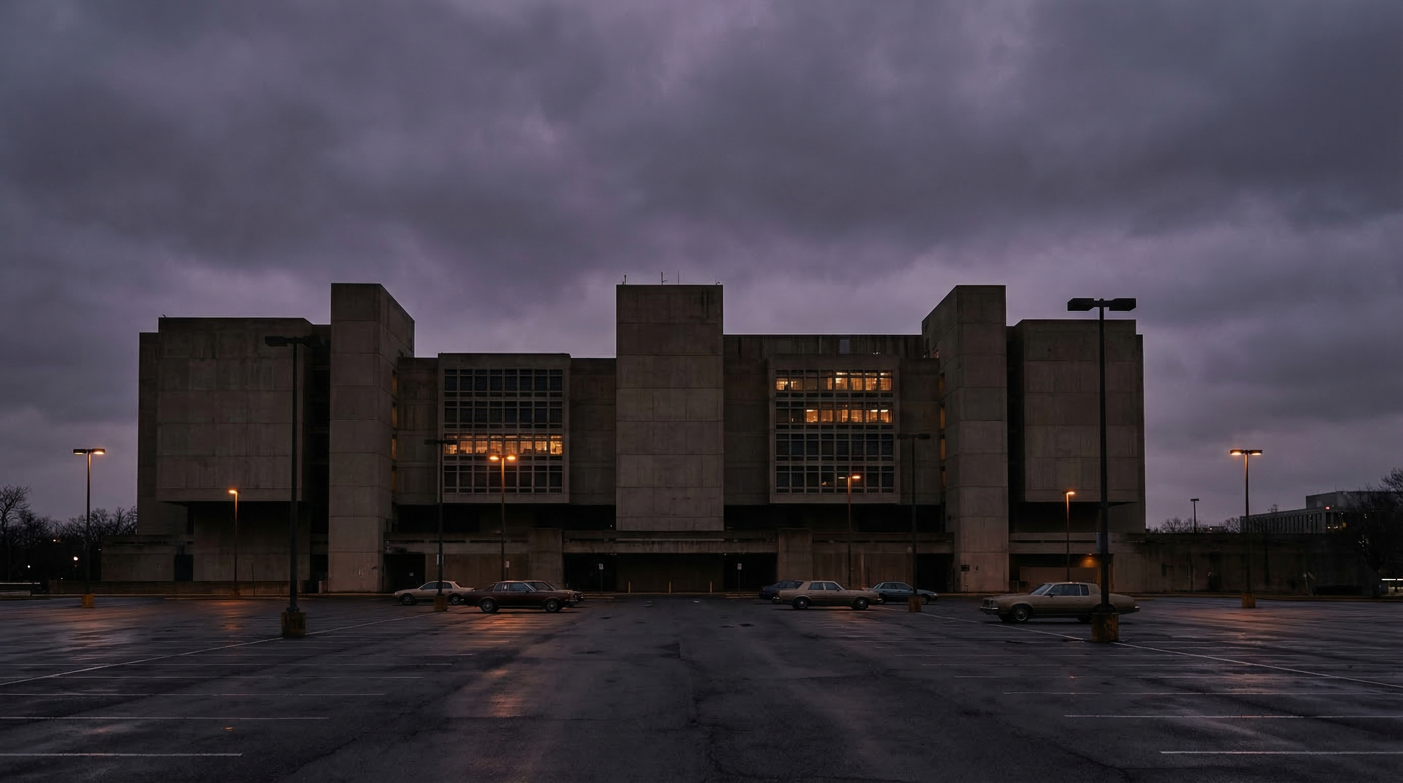 Federal government office building in Washington DC at dusk, empty parking lot, institutional architecture, muted purple and gray tones