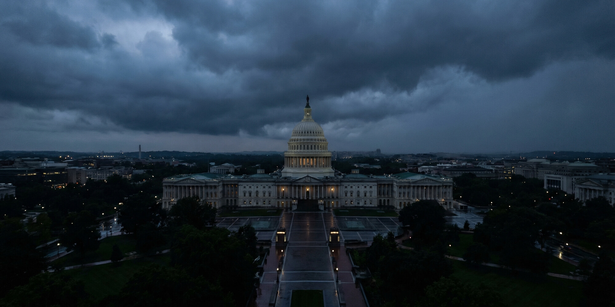 Aerial view of the United States Capitol building at dusk, Washington DC, dark blue-grey storm clouds — representing the historic federal debt interest milestone