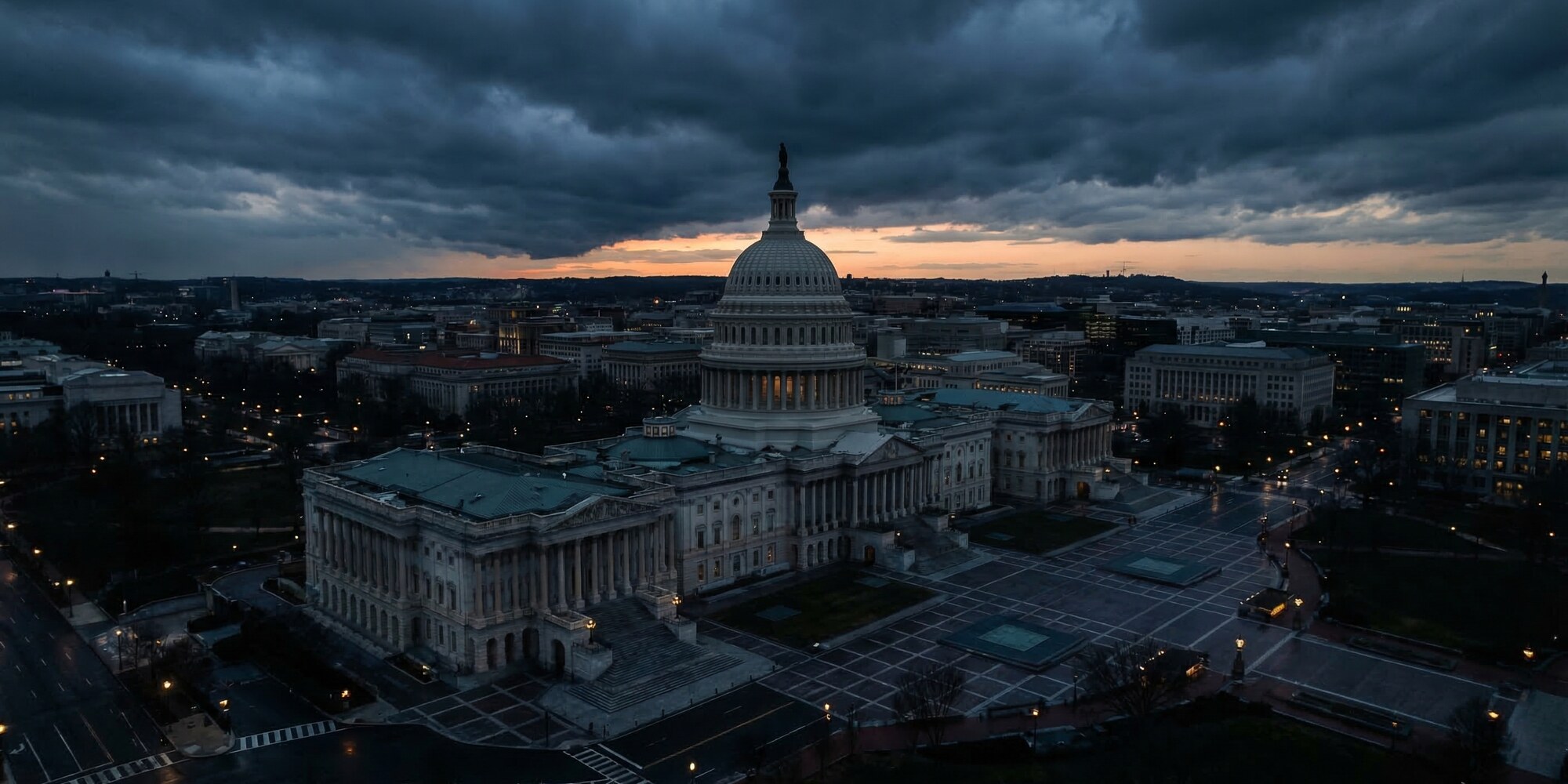 Aerial view of the United States Capitol building at dusk with dramatic storm clouds over Washington D.C., representing federal deficit spending and fiscal policy decisions